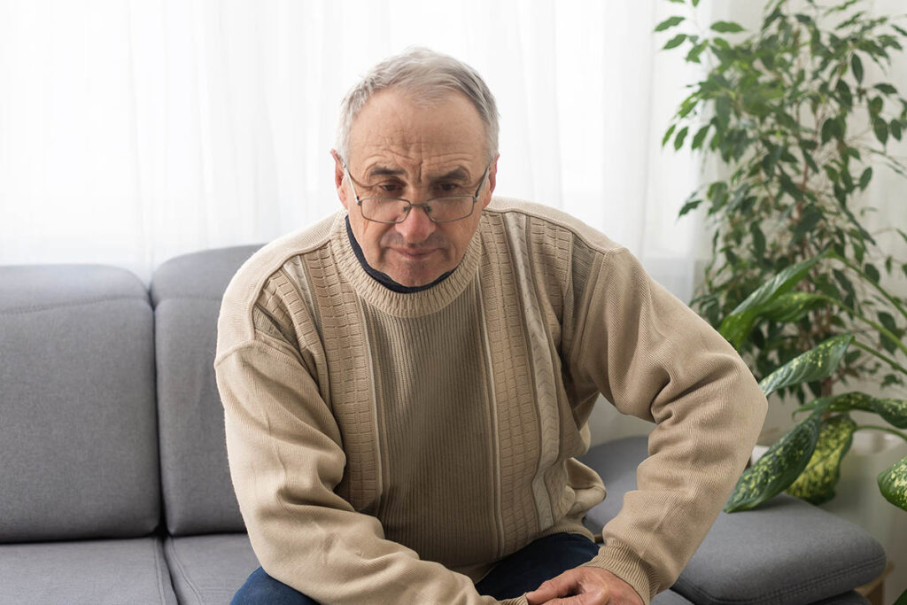 Elder man on sofa, loss of a loved-one, estate planning and probate.